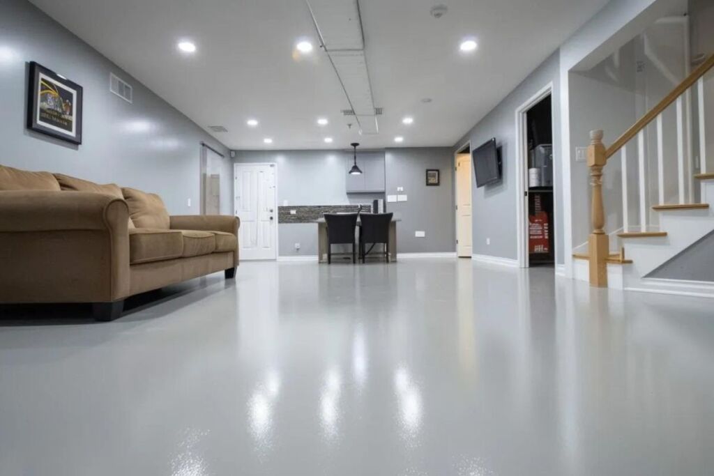 a sleek, vinyl basement floor shines under bright lights, showcasing a modern, easy-to-clean aesthetic perfect for a stylish and functional living space.